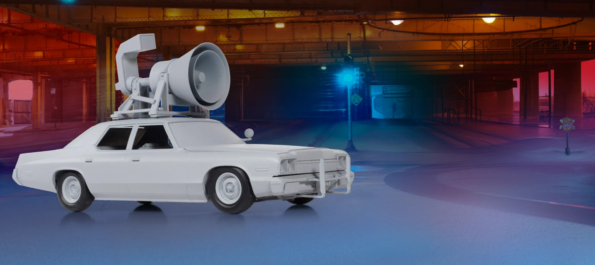 The Bluesmobile model with roof-mounted speaker under an elevated railway at night